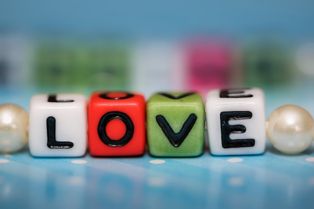 Photo love message written in wooden blocks.