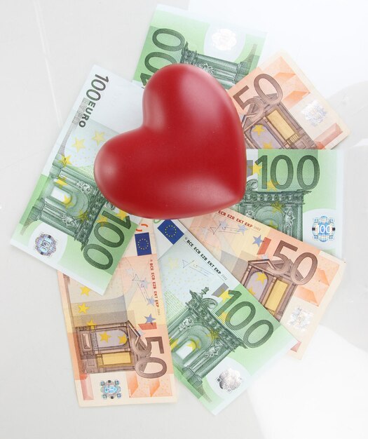 Love for money concept. Heart on European currency isolated on white