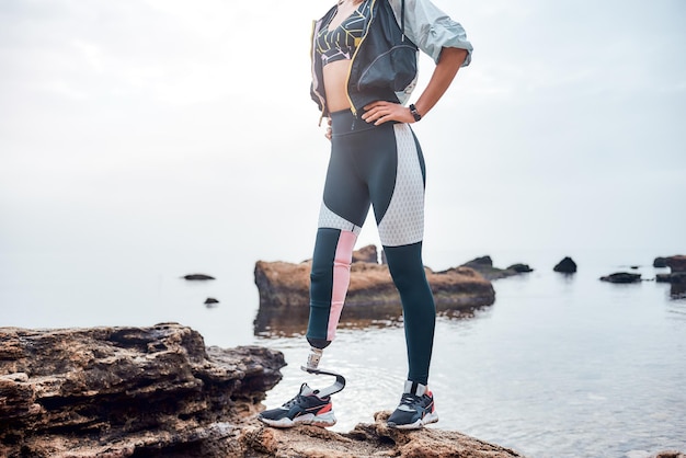 Love my unique body cropped image of sporty disabled woman in sportswear with bionic leg