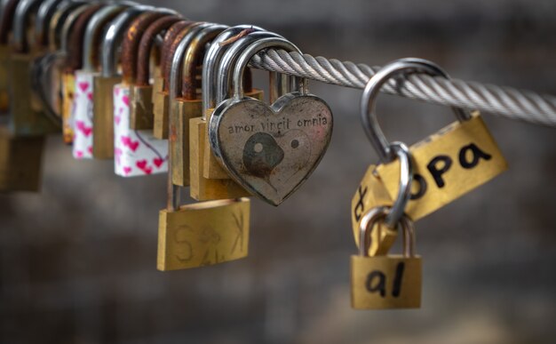 Love padlocks on a cable on a bridge