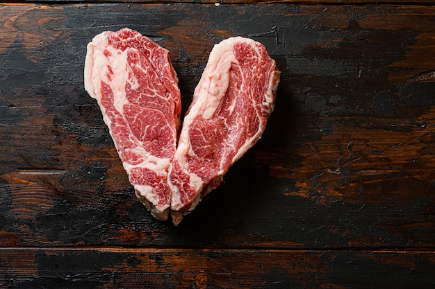 Love raw organic beef steak on vintage dark wood table
