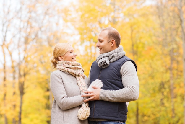 love, relationship, family and people concept - smiling couple in autumn park