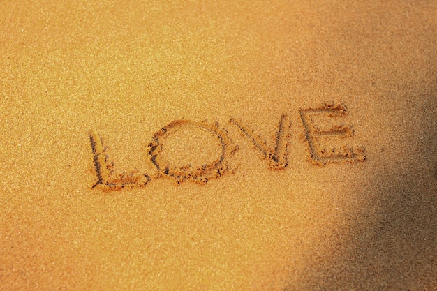 Photo love on sand beach.