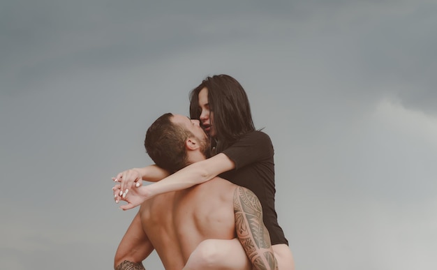 Love story Beautiful young couple hugging Couple is hugging Passion love couple Handsome muscular guy and amazing sexy woman Cosmopolitan couple Love and flirt