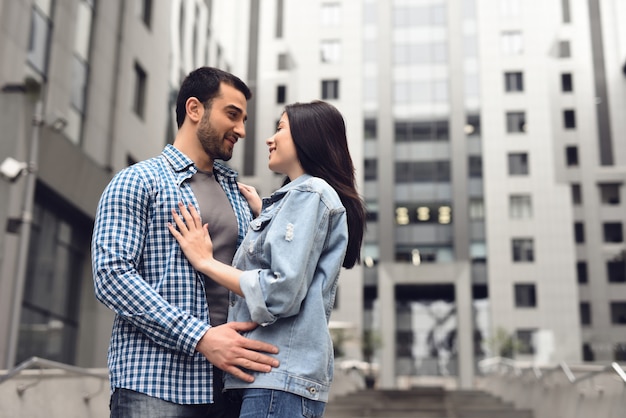 Photo love story in dull rainy day boy and girl hugging.