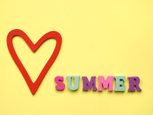 Love summer sigh card or poster with the word summer and a red heart on a yellow background