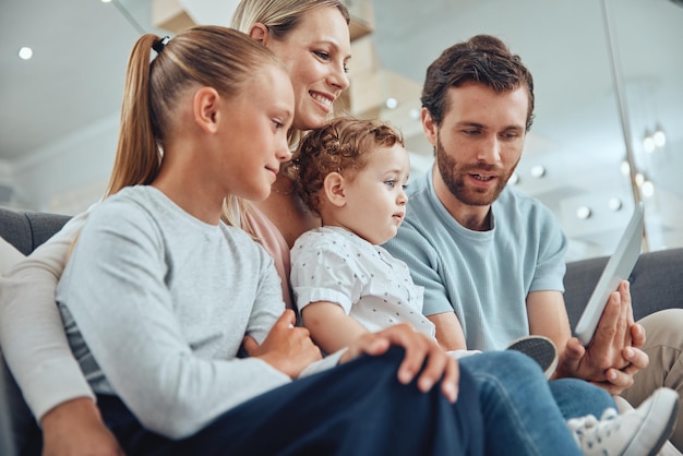 Love tablet and family in living room social media or smile for learning online chatting or parents Children mother or father with kids connection for happiness for cartoon or streaming on sofa