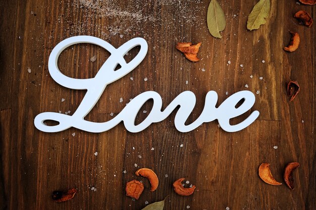 Love text card on wooden backdrop