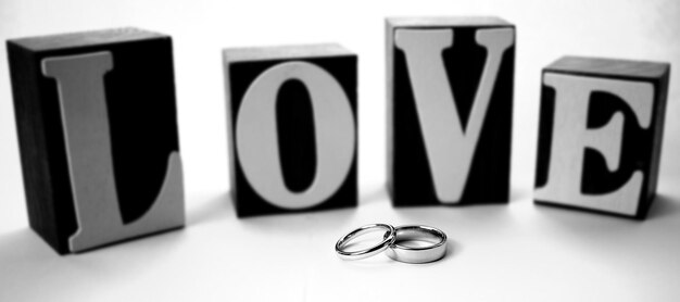 Photo love text with rings on white background