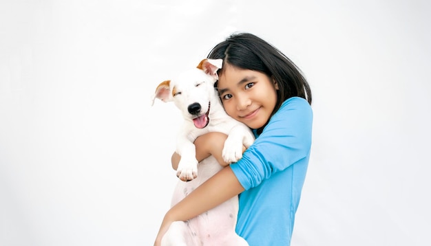 Love together kid and puppy dog on white isolated background