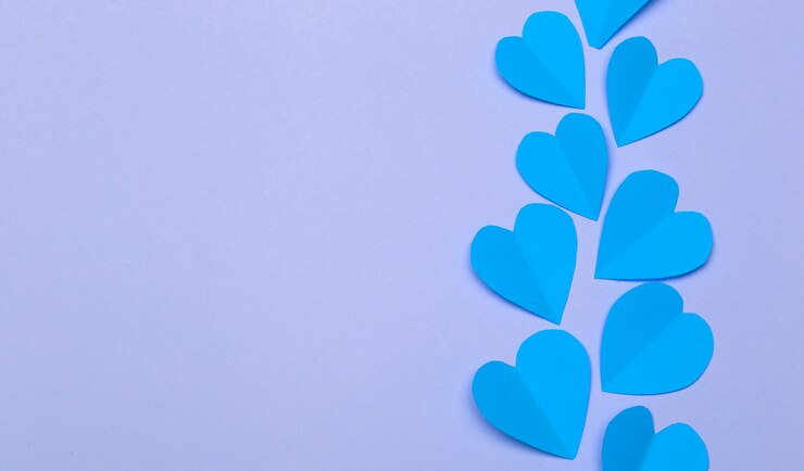 Love (Valentine's day) background or wedding background. Blue paper hearts on a purple pastel background. Love concept