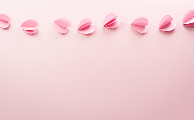 Photo love and valentine's day concept made from pink paper hearts on pastel background