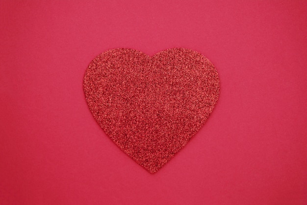 Love, Valentine's Day red background with glitter red heart. Flat lay.