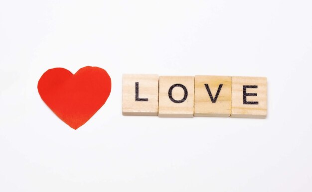 Love wooden block word with white background heart and love\
concept