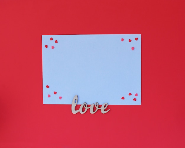 Love wooden text on white envelope on red 