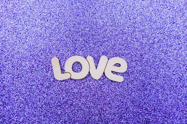 Love word, text on purple surface. Love and Valentine concept