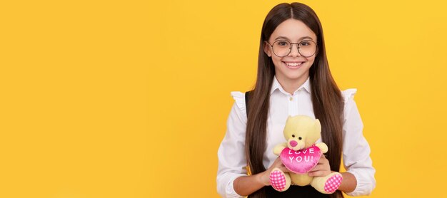 Love you Happy child smile holding teddy bear Valentines gift February 14 Valentines day Banner of child girl with toy studio portrait header with copy space