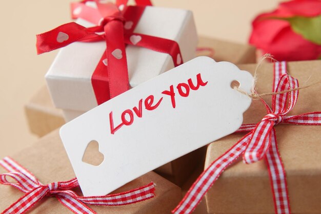 Love you text on a paper with gift box on table