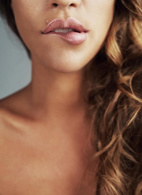 Photo love your lips cropped shot of a young woman biting her lips