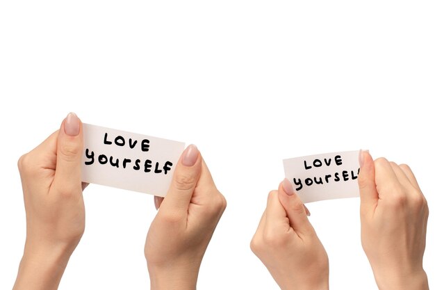 Photo love yourself text on a card in a woman hand isolated