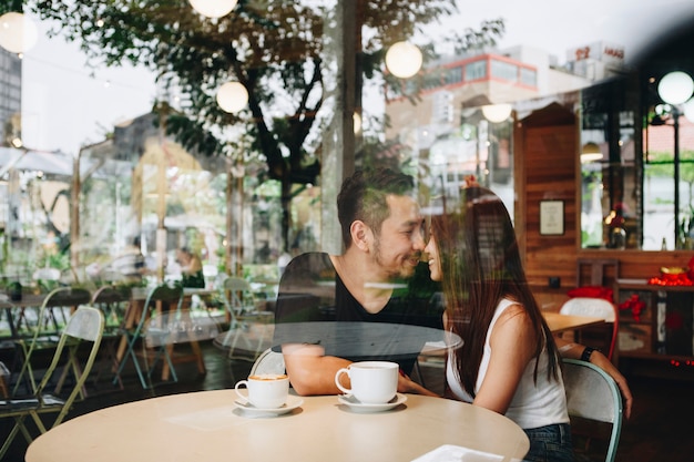 Lovely asian couple having coffee