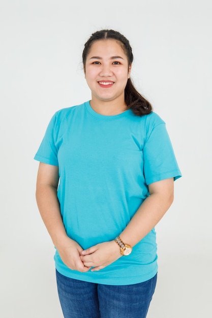 Lovely Asian female professional of health and beauty clinic politely standing with charming smile for warm welcome to friendly service. Cute girl happy to work on casual shirt of assistance employee.