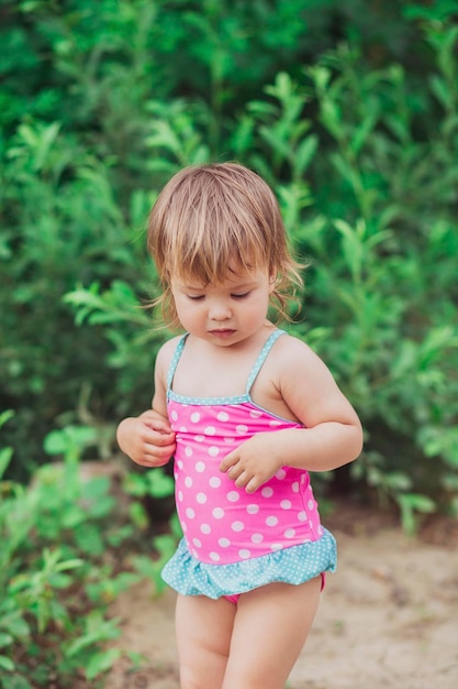 Lovely baby in swimsuit on the beach