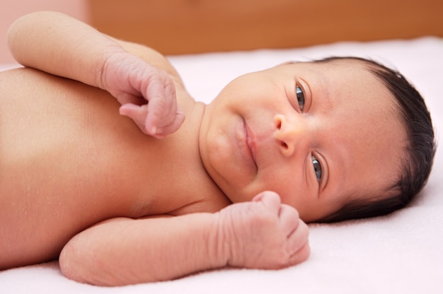 Lovely and beautiful baby on a pink towel