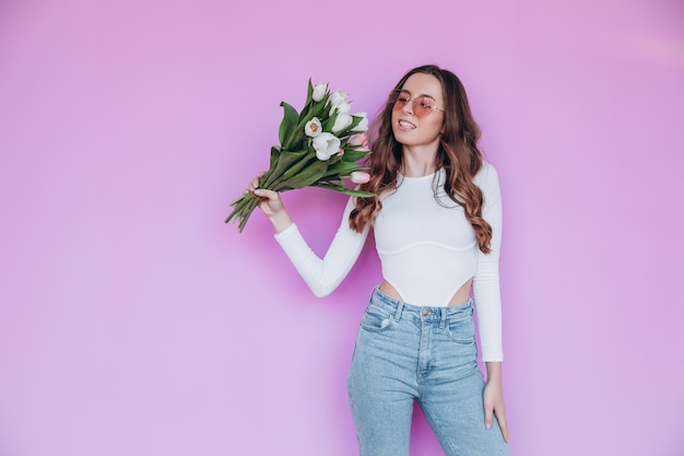 Lovely blonde getting bouquet of flowers for spring holiday. Festive concept