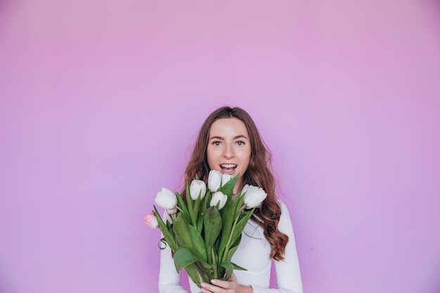 Lovely blonde getting bouquet of flowers for spring holiday. Festive concept