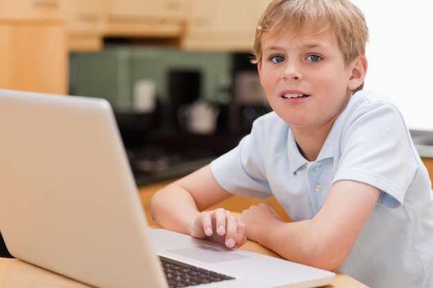 Lovely boy using a notebook