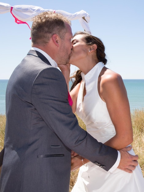 Lovely and cheerful wedding couple exchanging rings