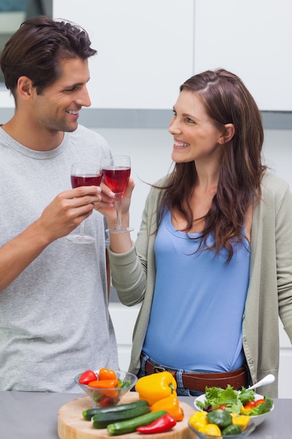 Lovely couple clinking glass of red wine