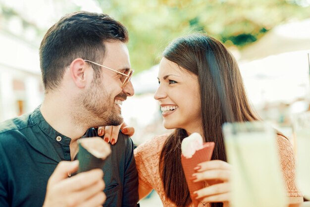 Lovely couple eating ice cream in the city