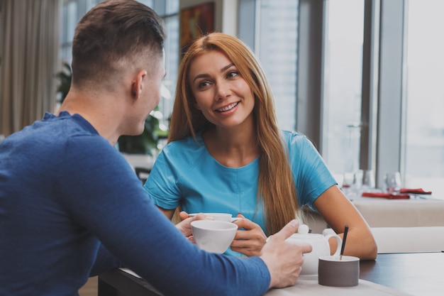 Lovely couple enjoying breakfast together at the restaurant