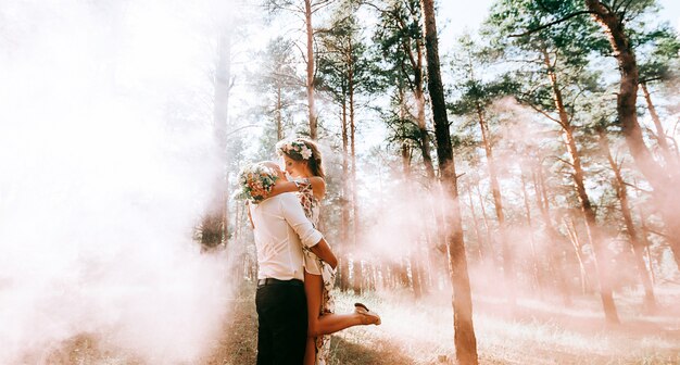 Lovely couple in a green forest