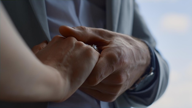 Lovely couple hands connecting in cloudy sky background Unity and love