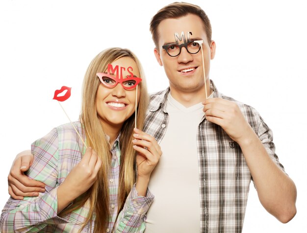 Lovely couple holding party glasses on stick