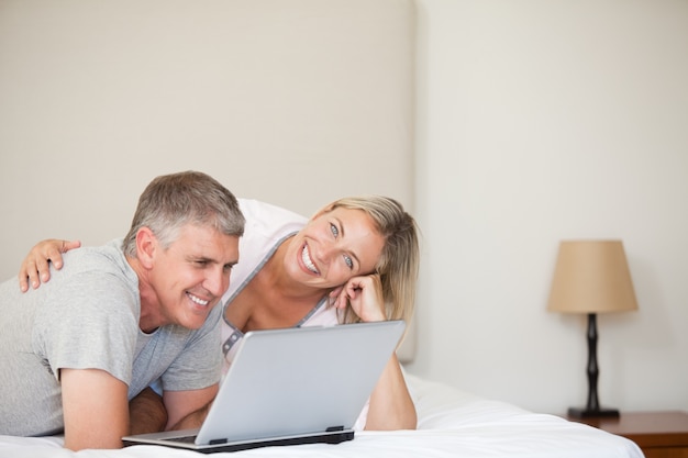 Lovely couple looking at their laptop