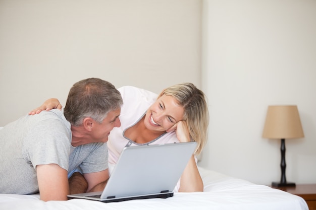 Lovely couple looking at their laptop