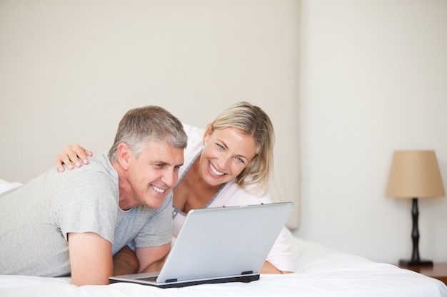 Lovely couple looking at their laptop