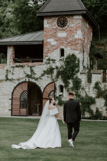 The lovely couple in love embracing and standing in the park