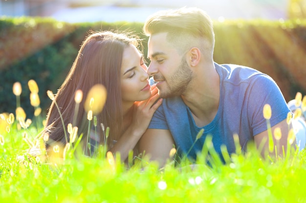 Lovely couple lying on green grass