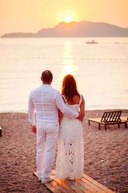 Lovely couple relax at luxury resort with sunlight together. Sunset with sea view