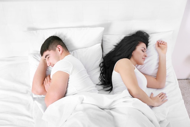 Lovely couple sleeping in white bed