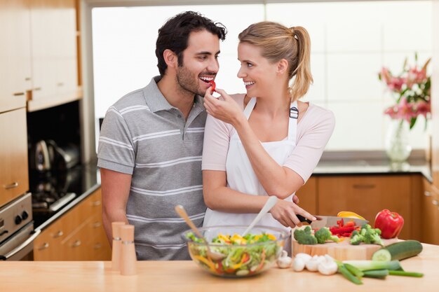 Lovely couple slicing pepper