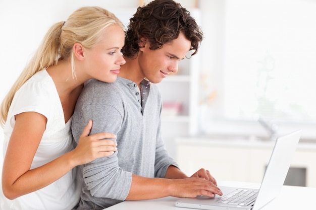 Lovely couple using a notebook