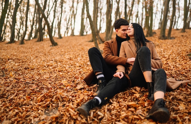 Lovely couple walking in the autumn forest