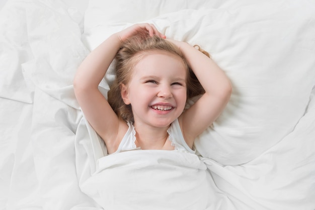 Lovely emotions of daughter smiling in bed