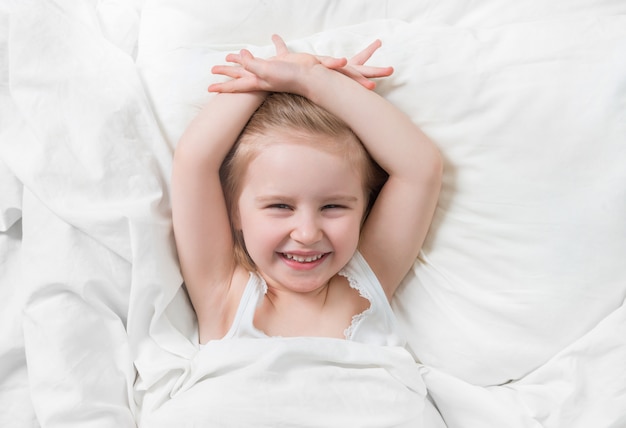 Lovely emotions of daughter smiling in bed